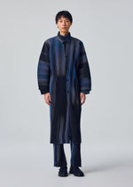 A model wears the HOMME PLISSÉ ISSEY MIYAKE BLEND OF LIGHTS blend-of-lights-shirt-brown.