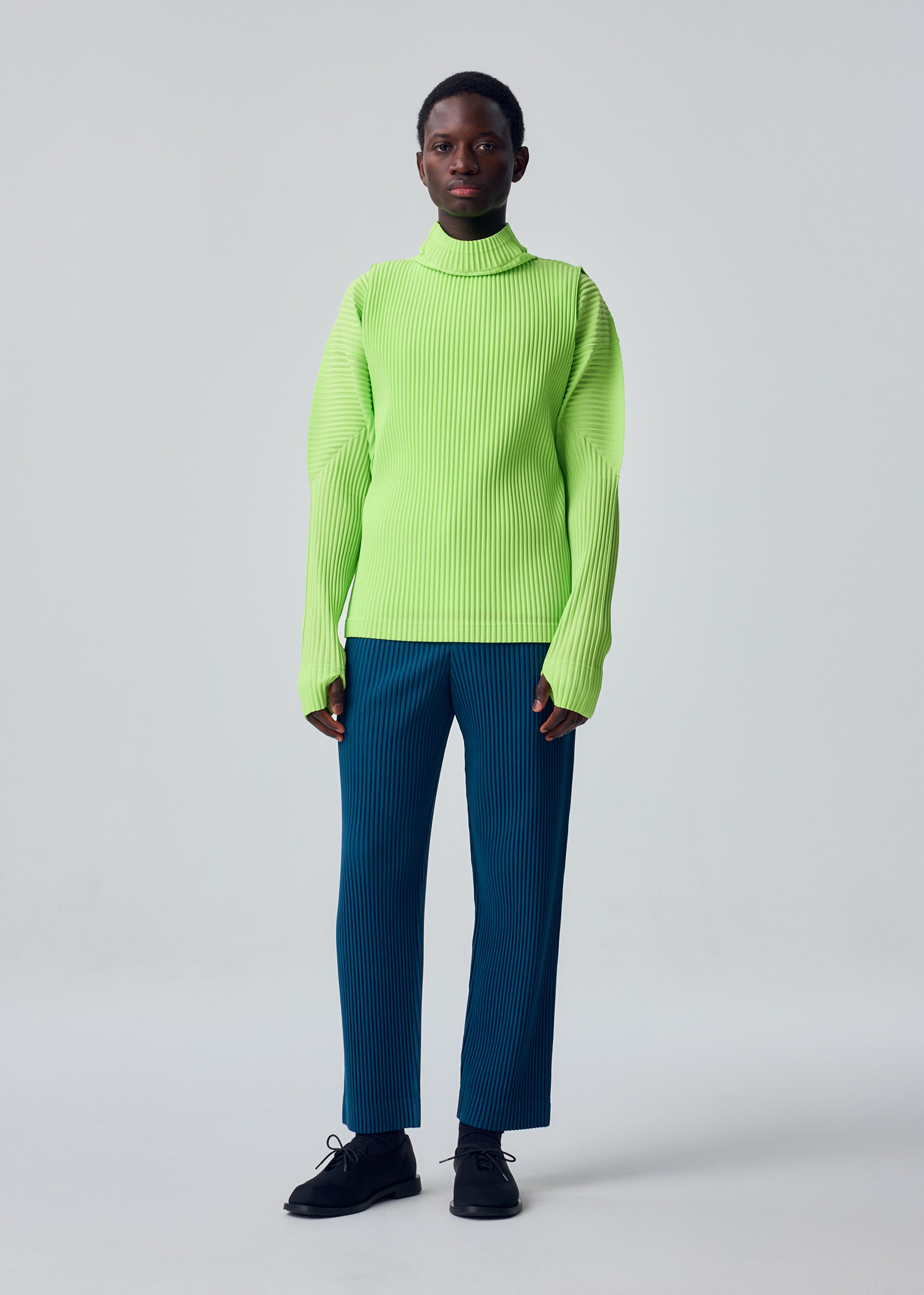 A model wears the HOMME PLISSÉ ISSEY MIYAKE COLOR PLEATS 1 color-pleats-1-t-shirt-ray-yellow.