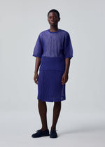 A model wears the HOMME PLISSÉ ISSEY MIYAKE RUSTIC MESH rustic-mesh-t-shirt-black.