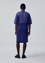 A model wears the HOMME PLISSÉ ISSEY MIYAKE RUSTIC MESH rustic-mesh-t-shirt-black.