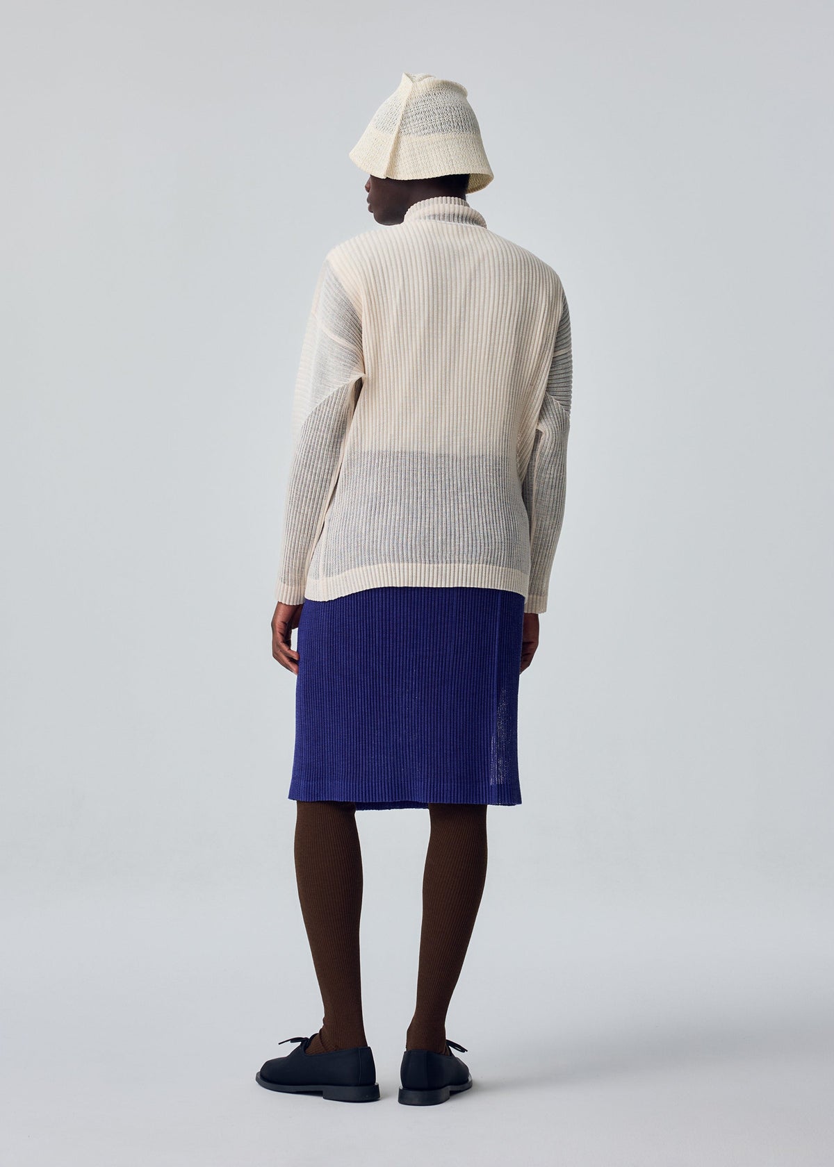 A model wears the HOMME PLISSÉ ISSEY MIYAKE RUSTIC MESH rustic-mesh-t-shirt-blue-5.