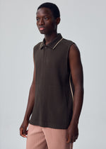 A model wears the HOMME PLISSÉ ISSEY MIYAKE EMBROIDERY STRIPES embroidery-stripes-vest-shade-greyish-brown.