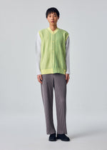 A model wears the HOMME PLISSÉ ISSEY MIYAKE IN THE SHADOW KNIT cardigan.