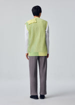 A model wears the HOMME PLISSÉ ISSEY MIYAKE IN THE SHADOW KNIT cardigan.