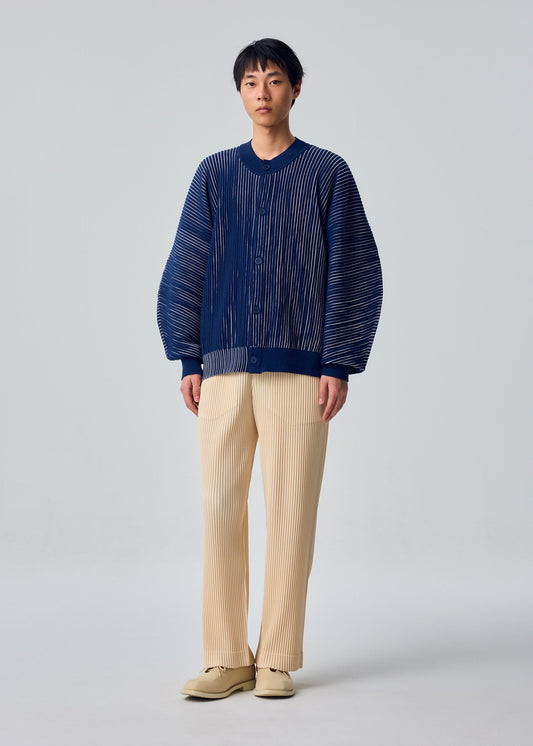 A model wears the HOMME PLISSÉ ISSEY MIYAKE IN THE SHADOW KNIT knit.