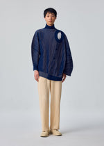 A model wears the HOMME PLISSÉ ISSEY MIYAKE IN THE SHADOW KNIT knit.