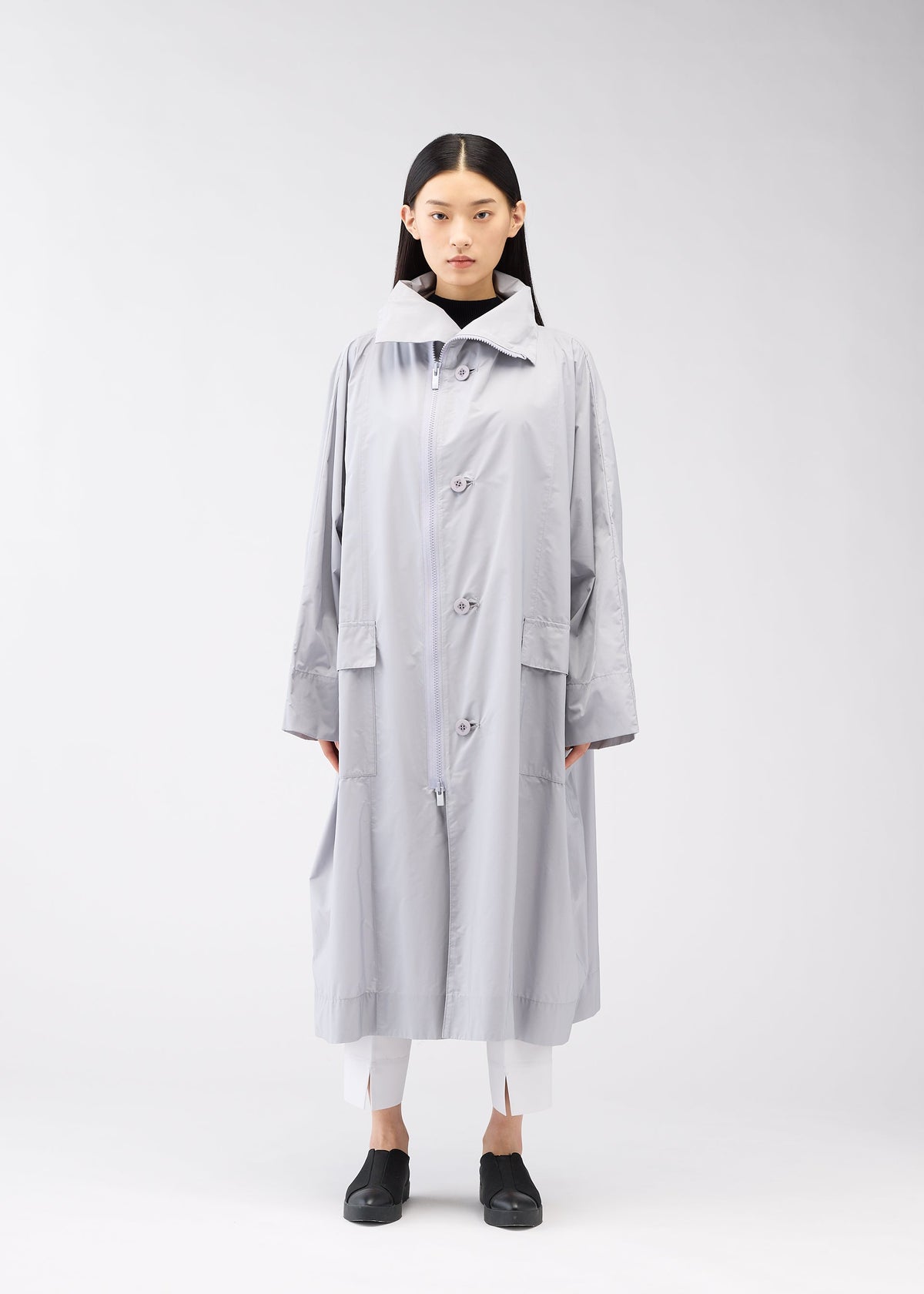 A model wears the 132 5. Issey Miyake FLAT WIND COAT coat.