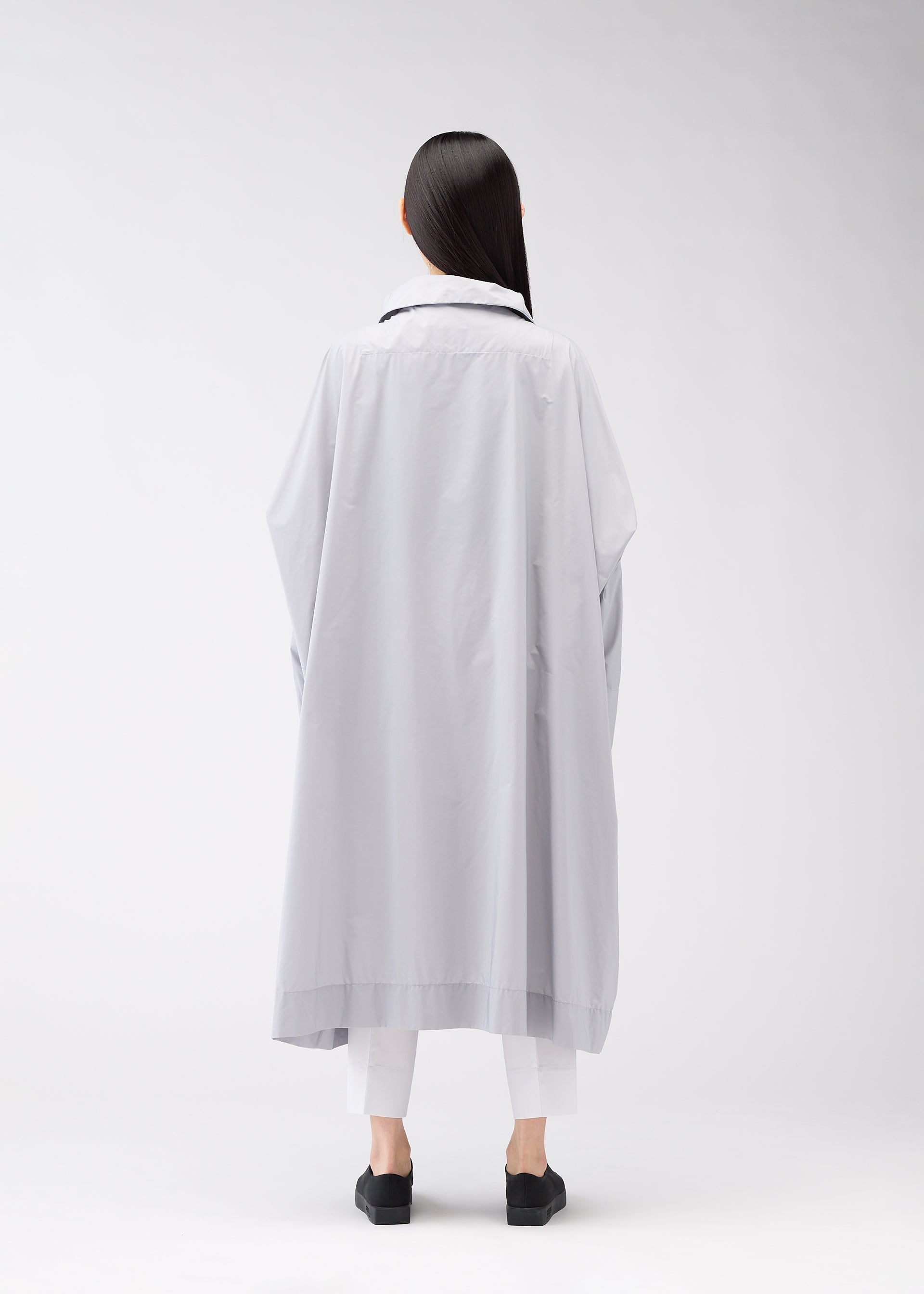 A model wears the 132 5. Issey Miyake FLAT WIND COAT coat.