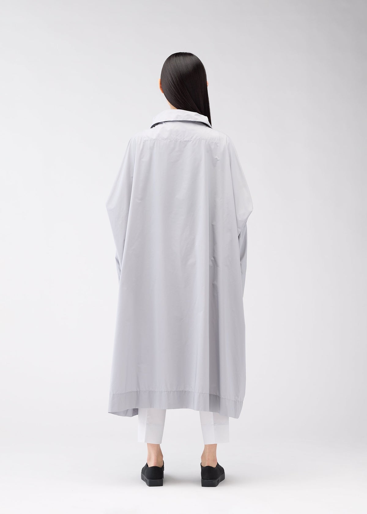 A model wears the 132 5. Issey Miyake FLAT WIND COAT coat.