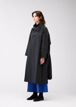 A model wears the 132 5. Issey Miyake 132 5. FLAT 2 coat.