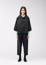 A model wears the 132 5. Issey Miyake 132 5. FLAT 1 jacket.