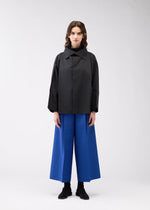 A model wears the 132 5. Issey Miyake 132 5. FLAT 2 jacket.