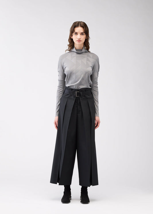 A model wears the 132 5. ISSEY MIYAKE FLAT SIDE FOLD trousers.