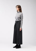 A model wears the 132 5. Issey Miyake FLAT SIDE FOLD trousers.