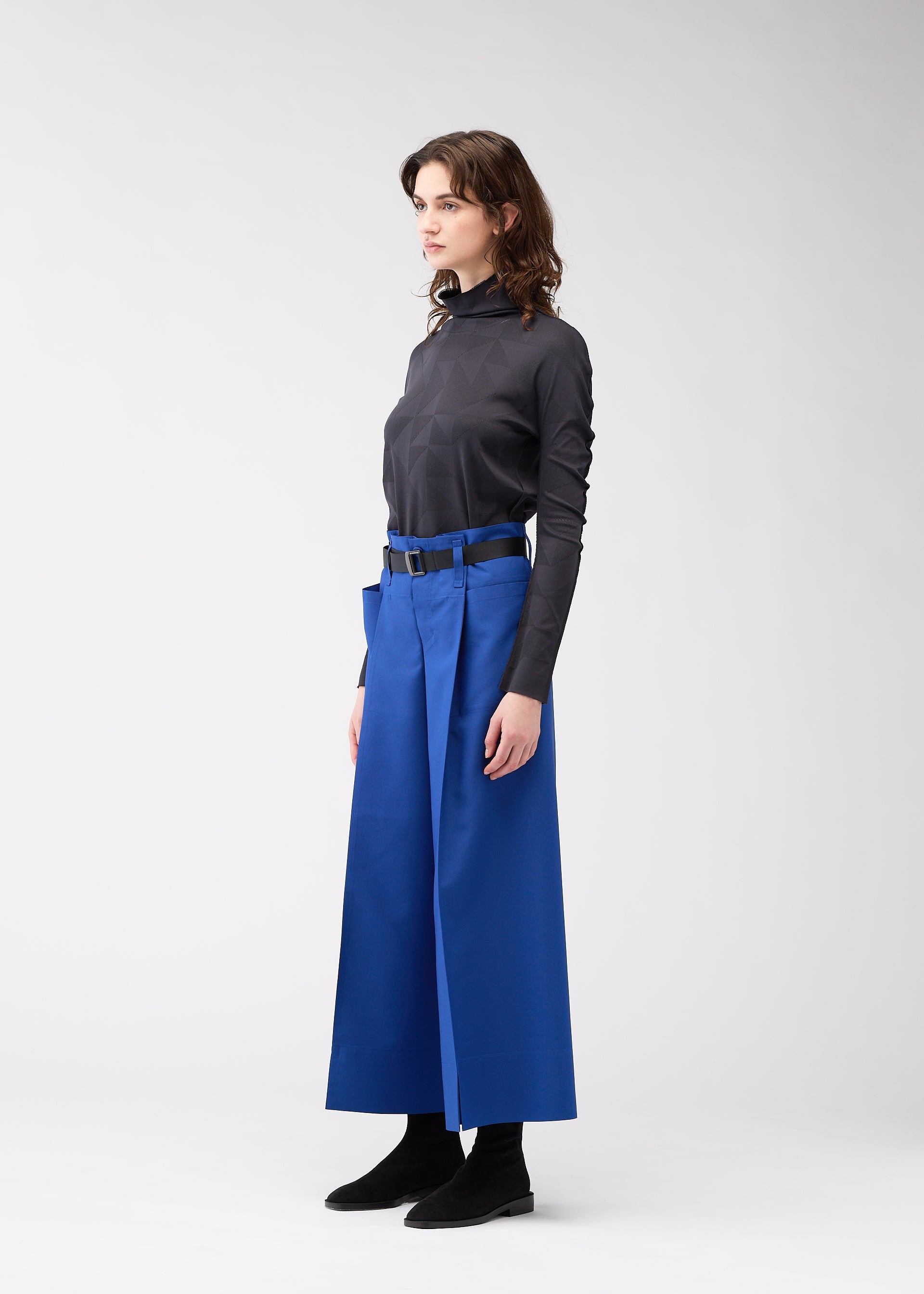 A model wears the 132 5. Issey Miyake 132 5. FLAT 2 trousers.