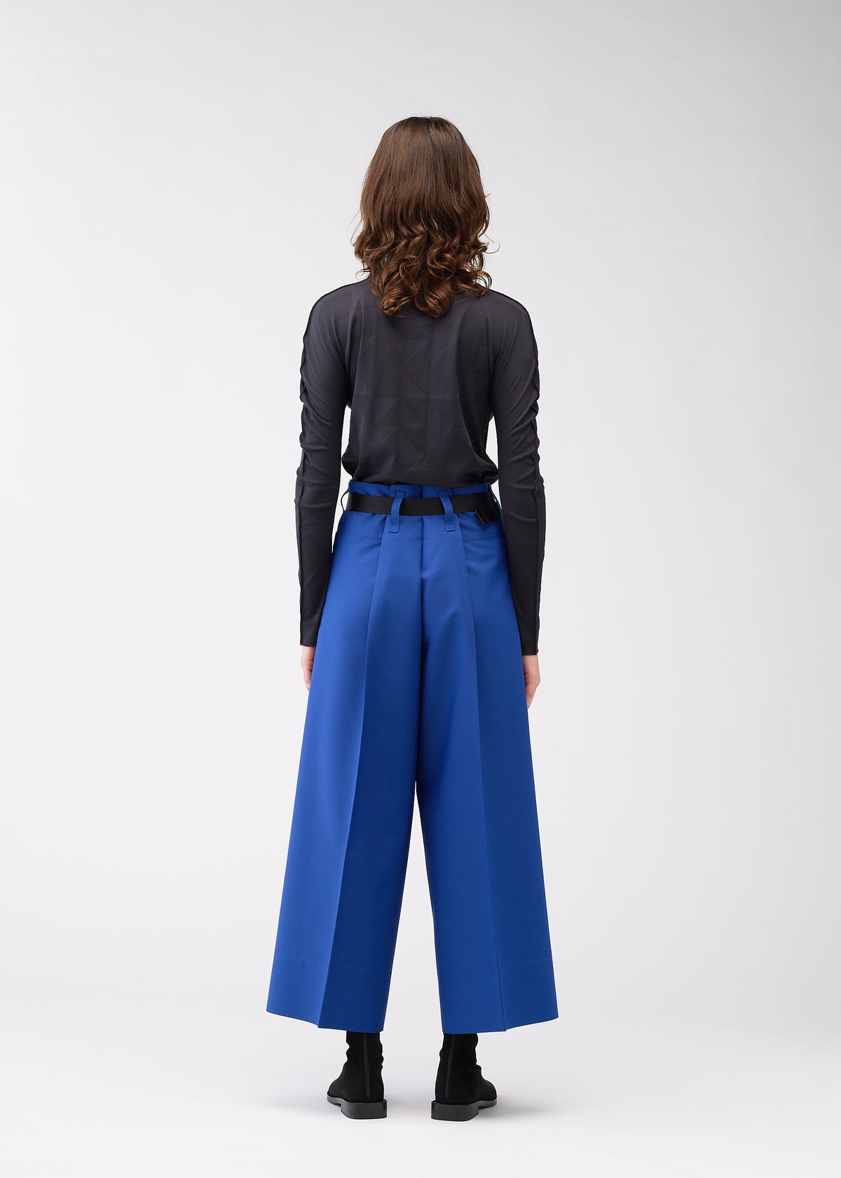 A model wears the 132 5. Issey Miyake 132 5. FLAT 2 trousers.