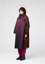 A model wears the 132 5 ISSEY MIYAKE GRADATION COAT prêt à porter.