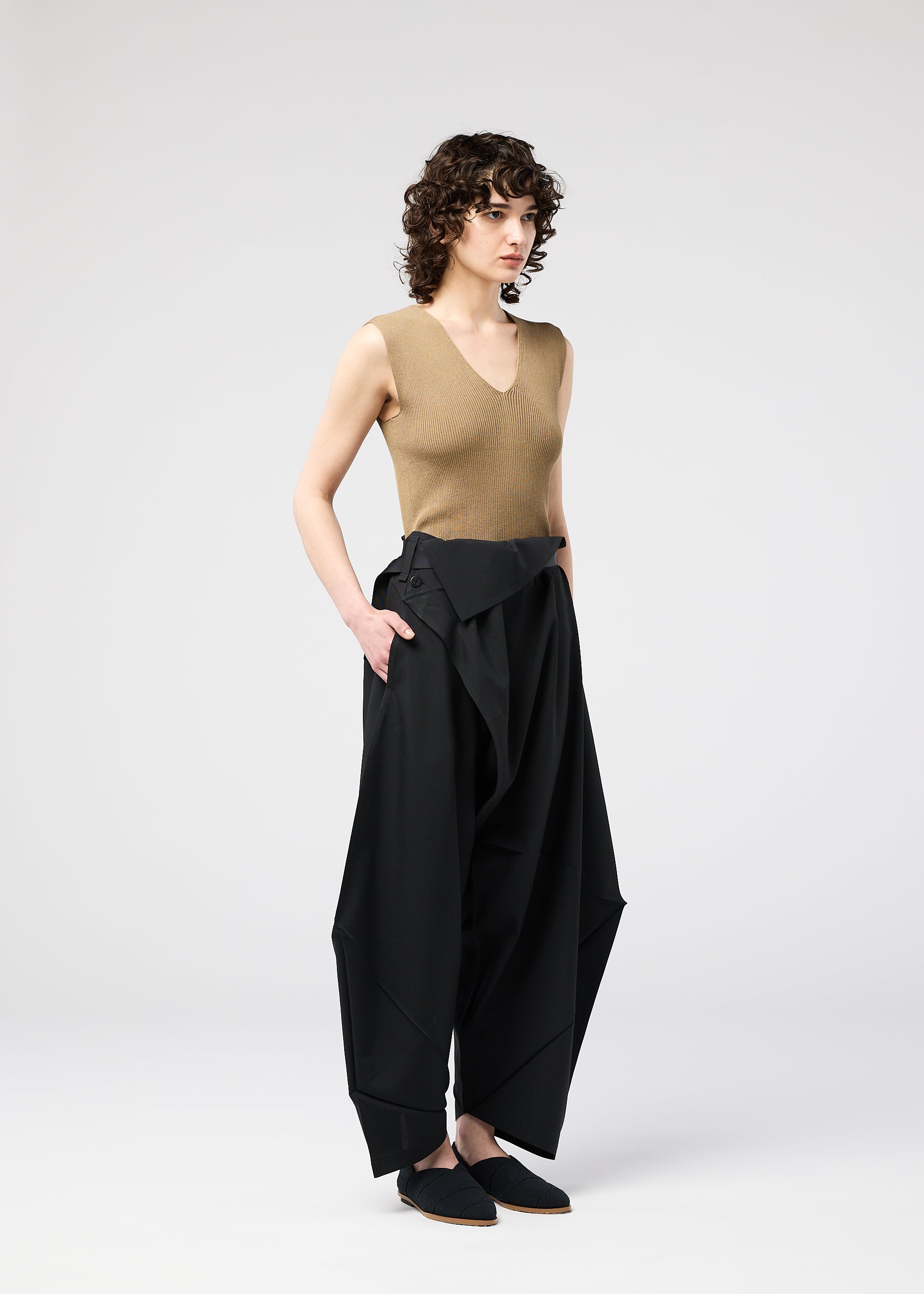 A model wears the 132 5. Issey Miyake FACET SOLID pants.