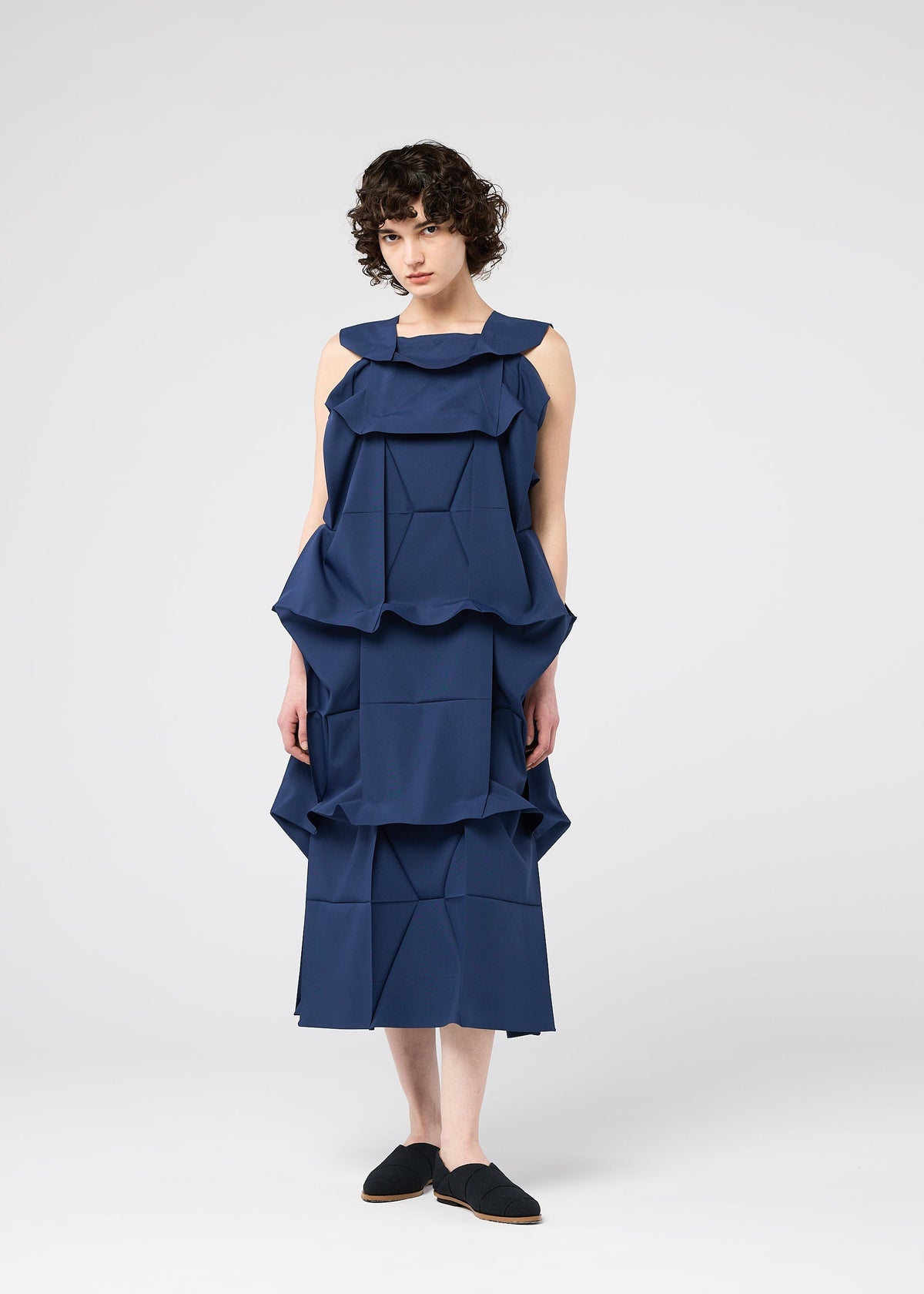A model wears the 132 5. ISSEY MIYAKE NO.6 SOLID no-6-solid-dress-navy.
