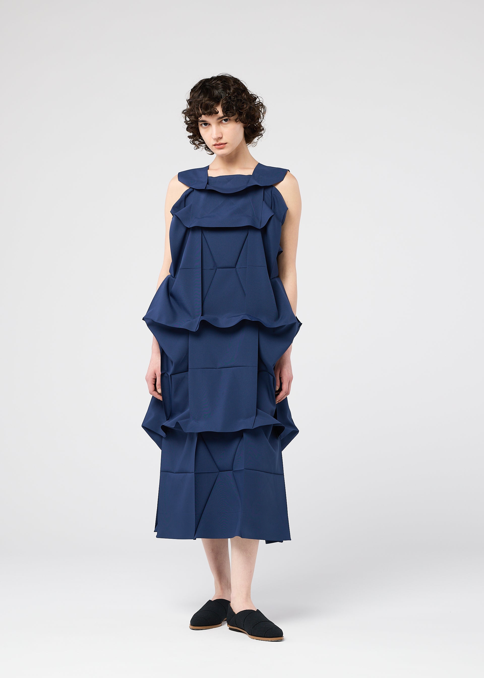 A model wears the 132 5. ISSEY MIYAKE NO.6 SOLID no-6-solid-dress-navy.