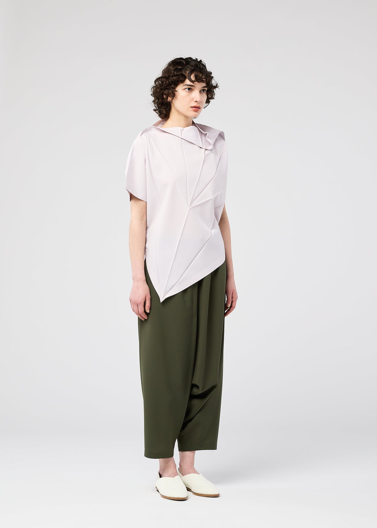 A model wears the 132 5. Issey Miyake RADIAL FOLD Top top.