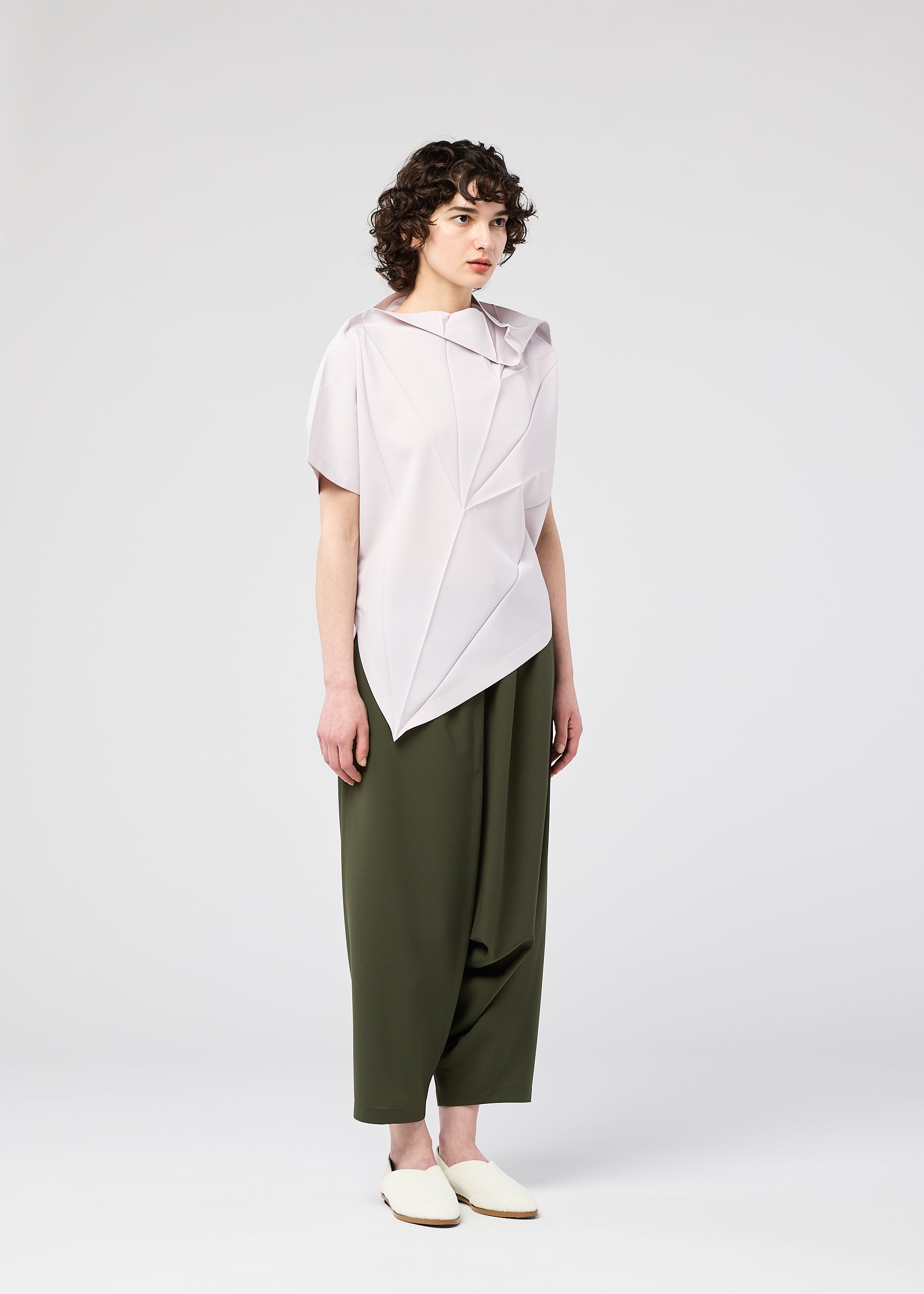 A model wears the 132 5. Issey Miyake RADIAL FOLD Top top.