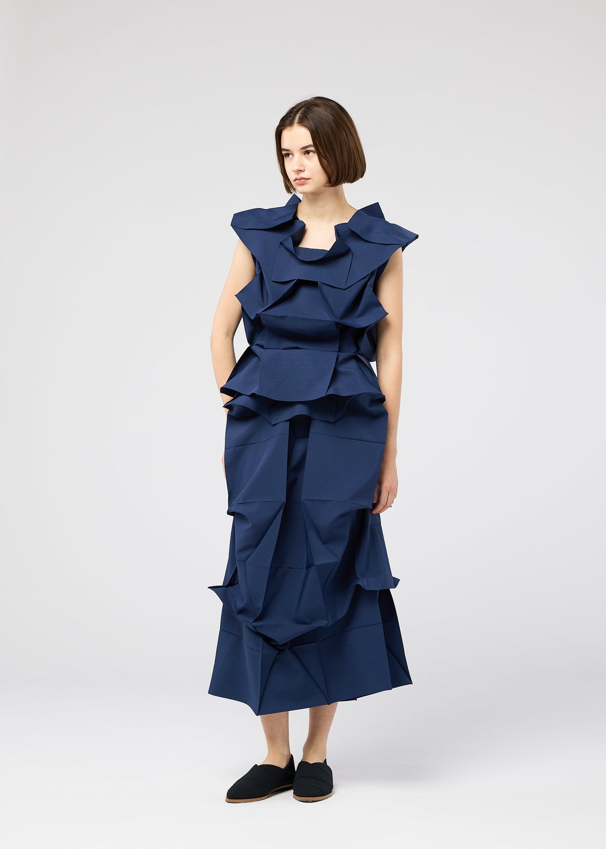 A model wears the 132 5. ISSEY MIYAKE NO.6 SOLID no-6-solid-shirt-navy.