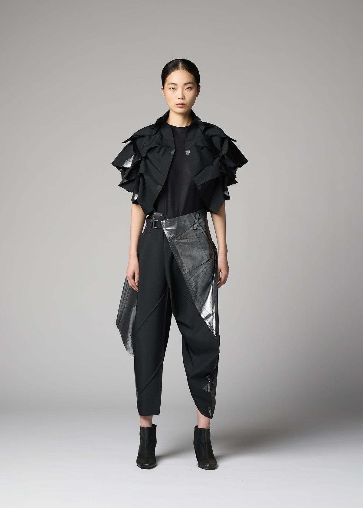 A model wears the 132 5. ISSEY MIYAKE No.10-1 no-10-1-cardigan-black-x-silver-1.