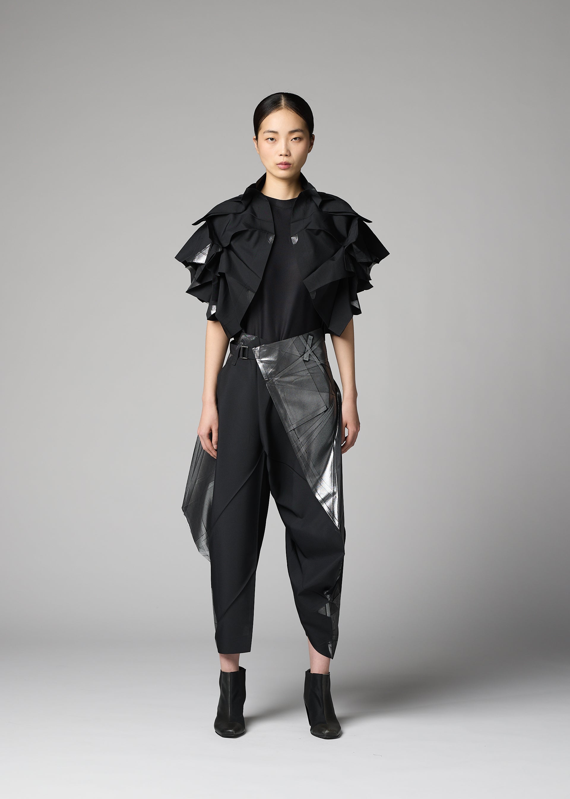 A model wears the 132 5. ISSEY MIYAKE No.10-1 no-10-1-cardigan-white-x-silver.