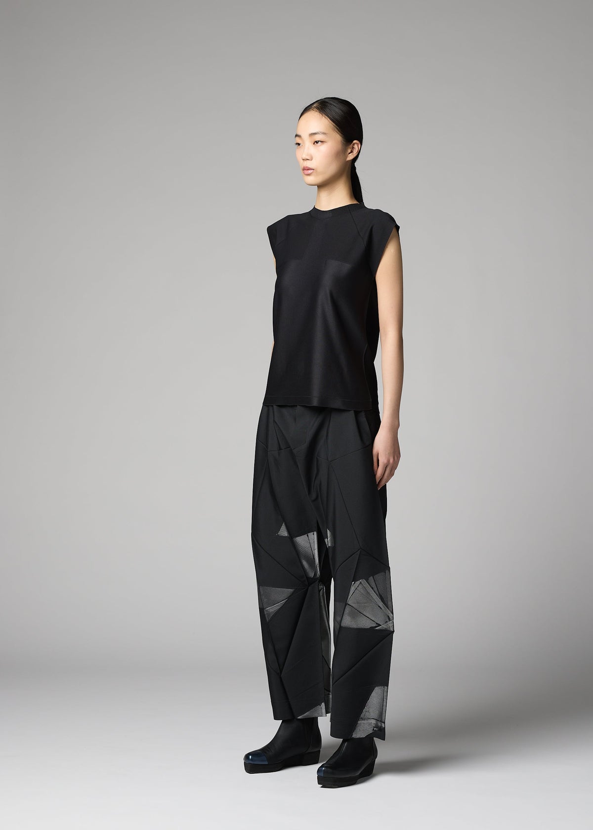 A model wears the 132 5. ISSEY MIYAKE F-KN f-kn-blouse-black.