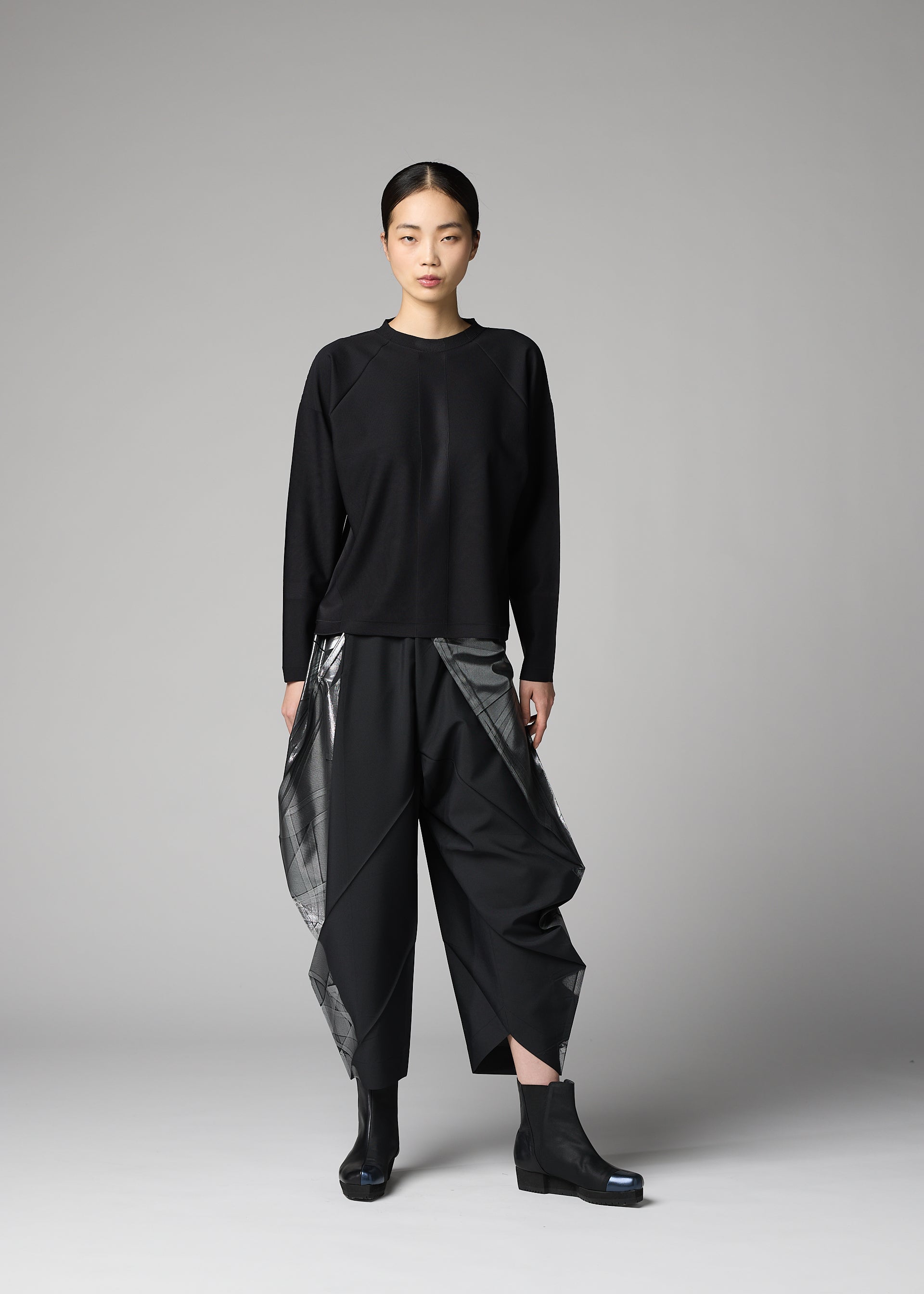 A model wears the 132 5. ISSEY MIYAKE F-KN f-kn-blouse-black-1.