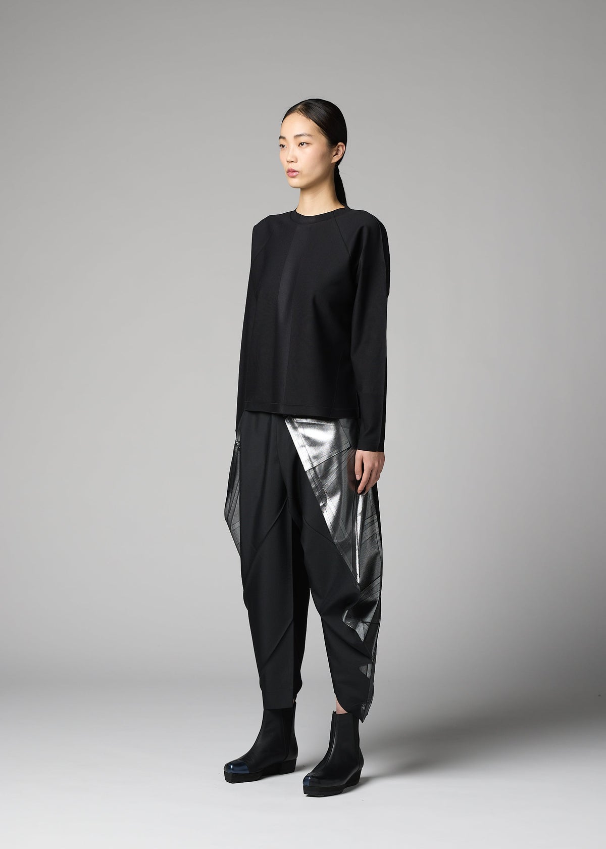 A model wears the 132 5. ISSEY MIYAKE F-KN f-kn-blouse-black-1.