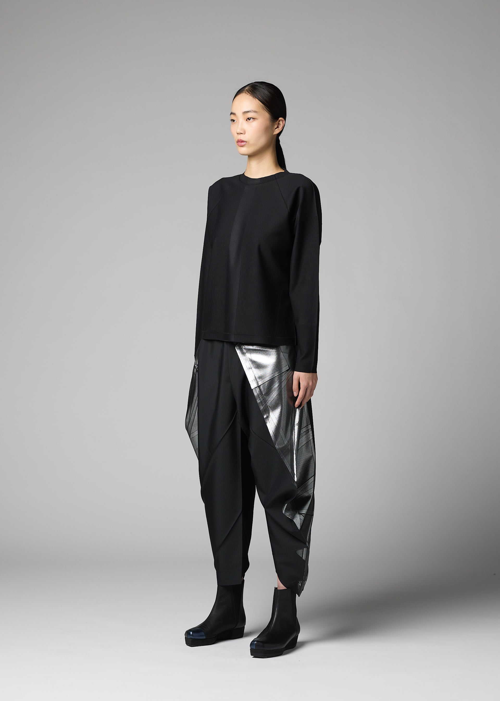 A model wears the 132 5. ISSEY MIYAKE F-KN f-kn-blouse-black-1.