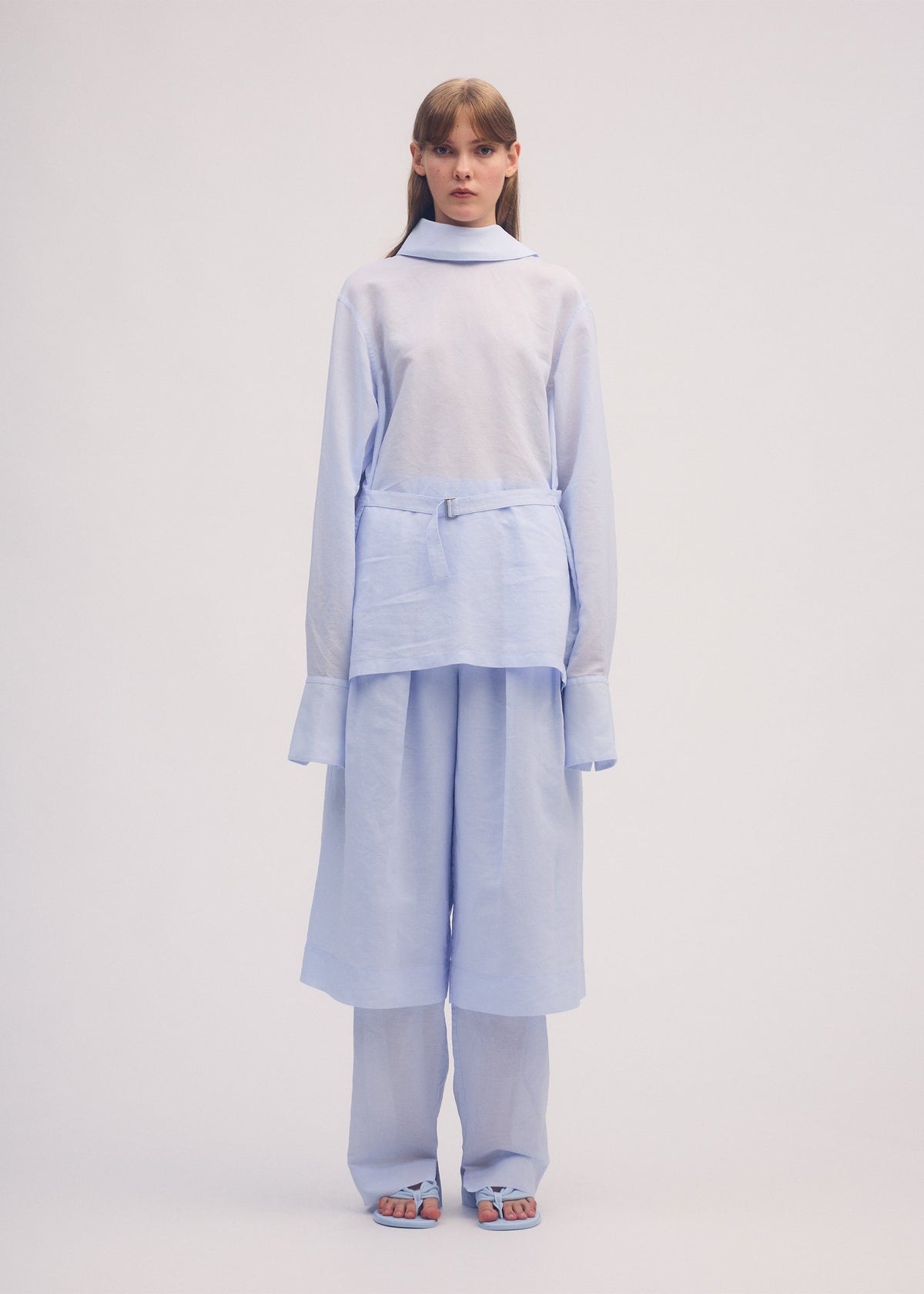 A model wears the ISSEY MIYAKE PAPER ESQUE U shirt.