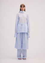 A model wears the ISSEY MIYAKE PAPER ESQUE U shirt.