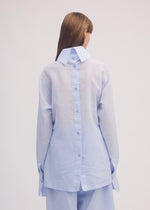 A model wears the ISSEY MIYAKE PAPER ESQUE U shirt.