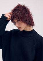 A model wears the Issey Miyake ODD BEANIE cap.