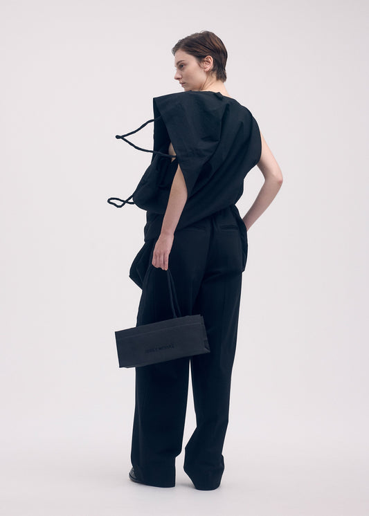 A model wears the ISSEY MIYAKE THIS IS A PAPER BAG bag.