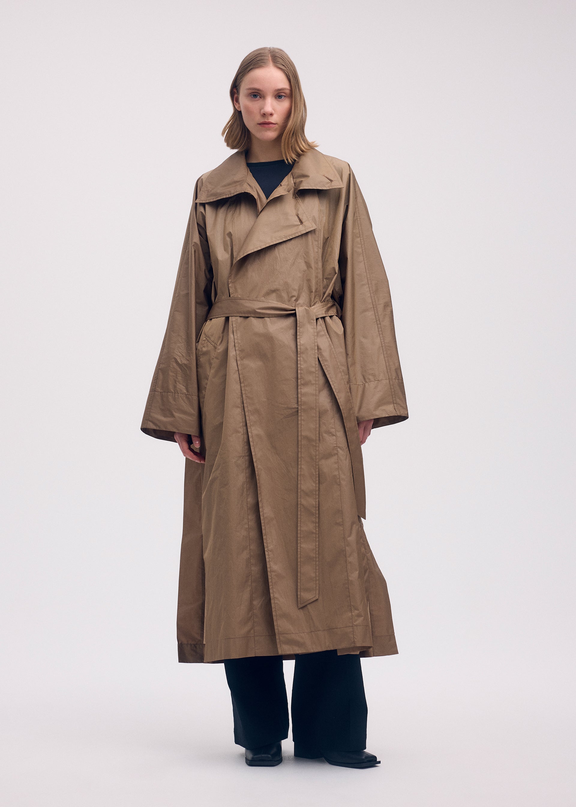 A model wears the Issey Miyake AERIAL STEEL coat.