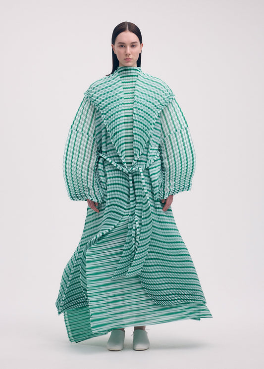 A model wears the Issey Miyake GENERIC STRIPES HAND PLEATS coat.