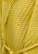 A model wears the Issey Miyake GENERIC STRIPES HAND PLEATS coat.