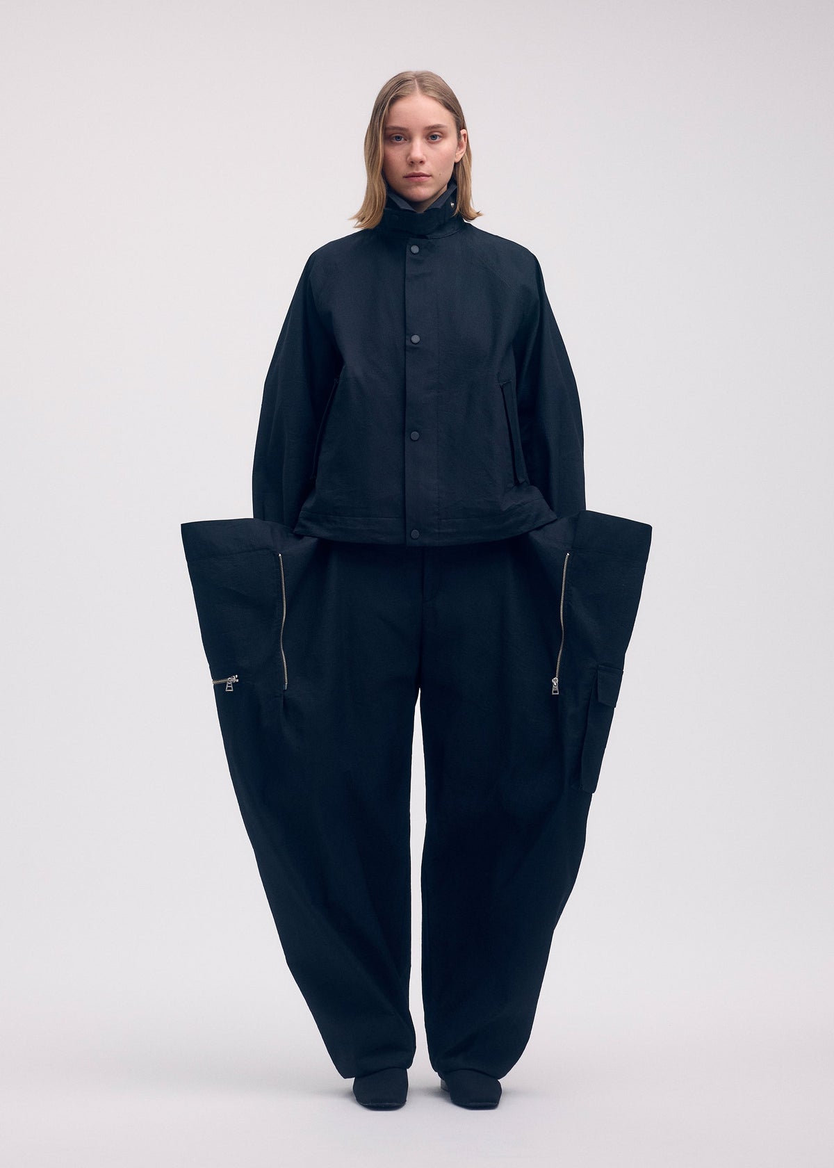 A model wears the Issey Miyake PEEKABOO jacket.