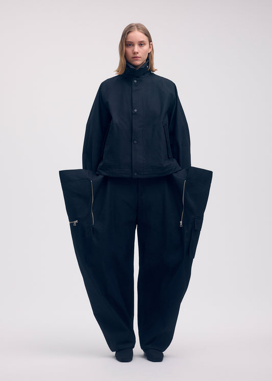 A model wears the Issey Miyake PEEKABOO jacket.