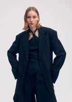 A model wears the Issey Miyake UNI FORM WOOL jacket.