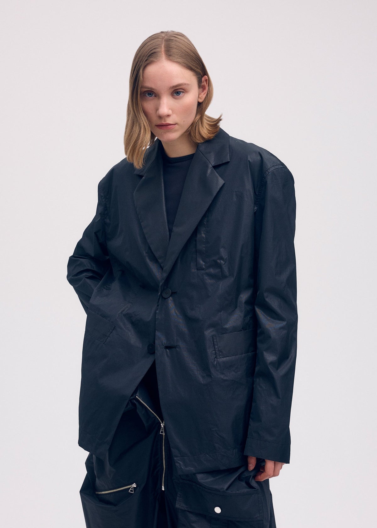 A model wears the Issey Miyake AERIAL STEEL jacket.