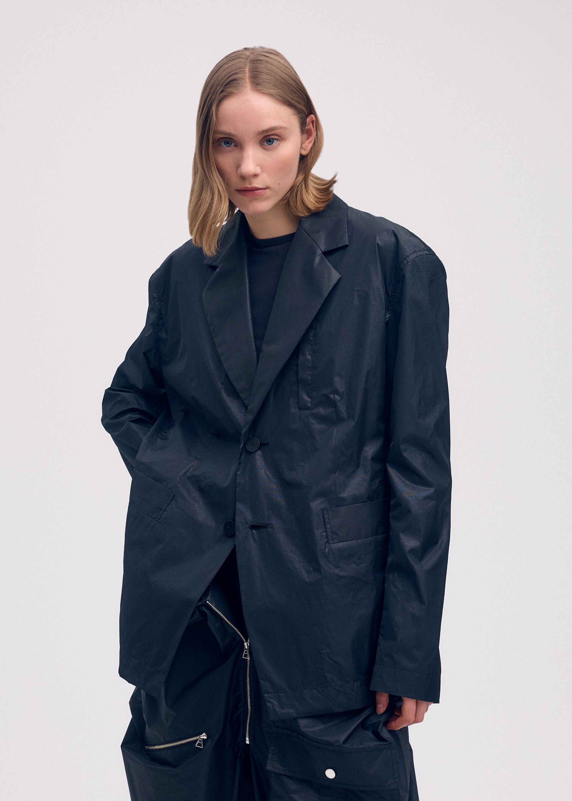 A model wears the Issey Miyake AERIAL STEEL jacket.