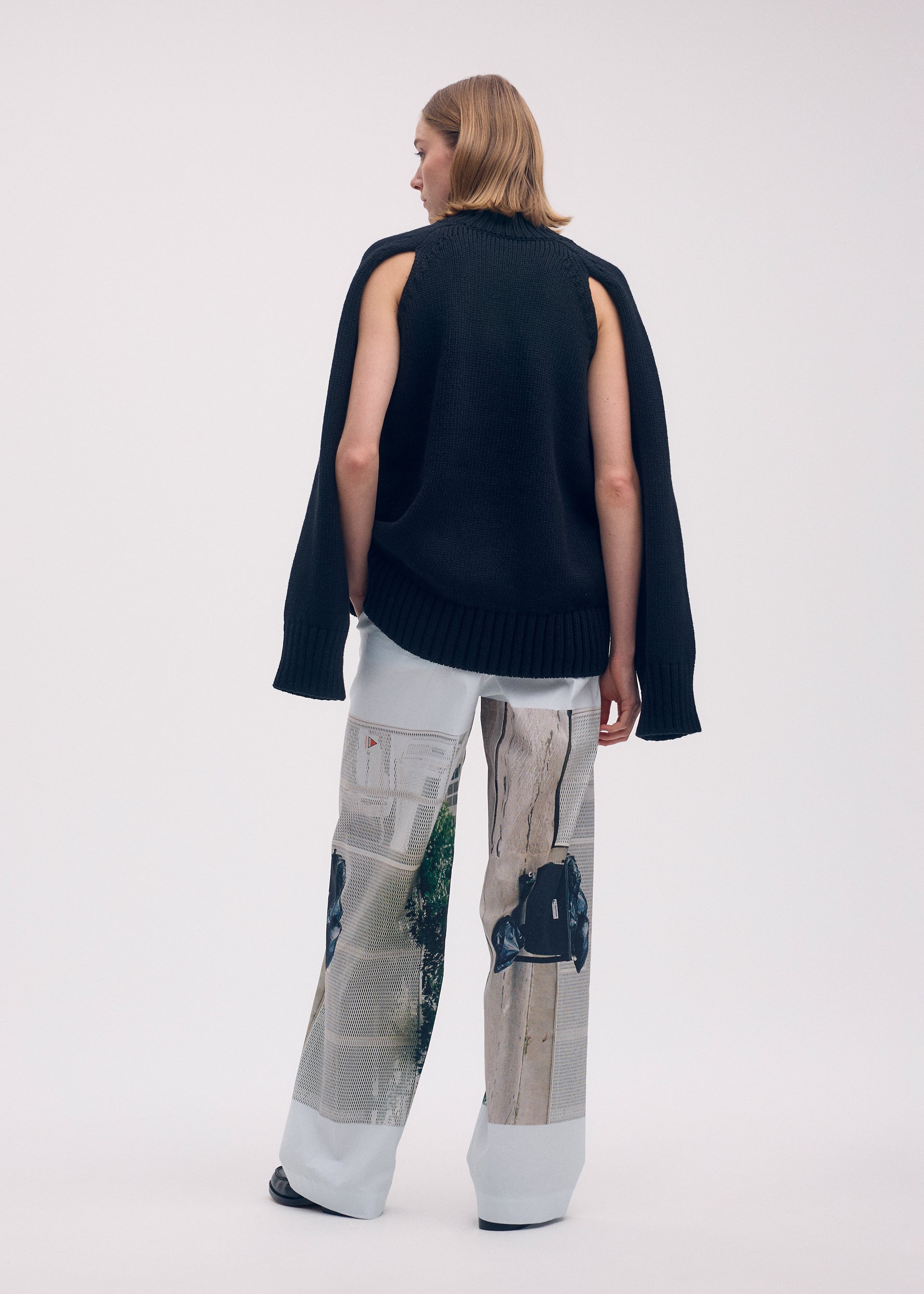 A model wears the Issey Miyake STREET VIEW trousers.