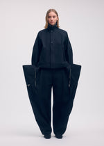 A model wears the Issey Miyake PEEKABOO trousers.
