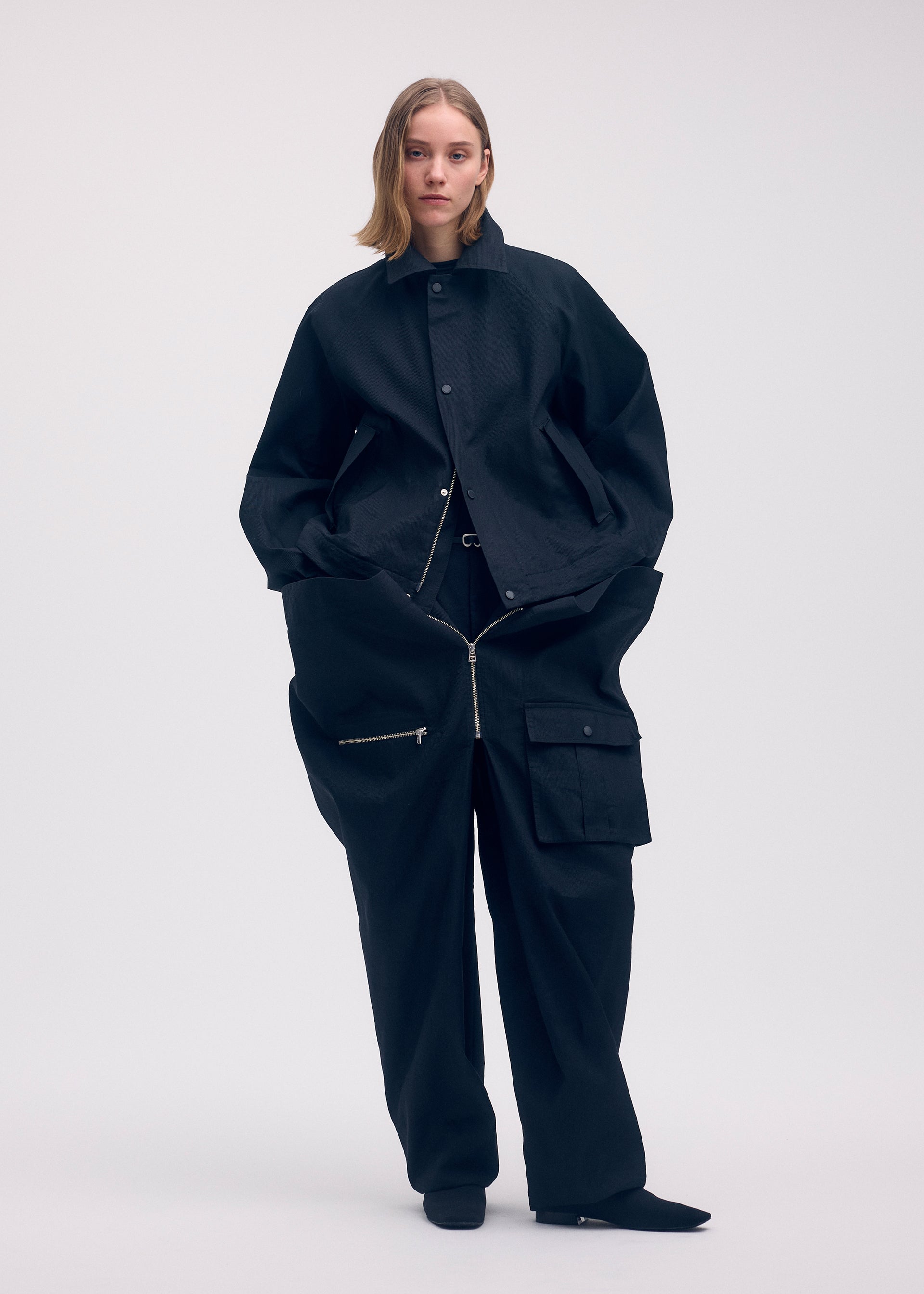 A model wears the Issey Miyake PEEKABOO trousers.