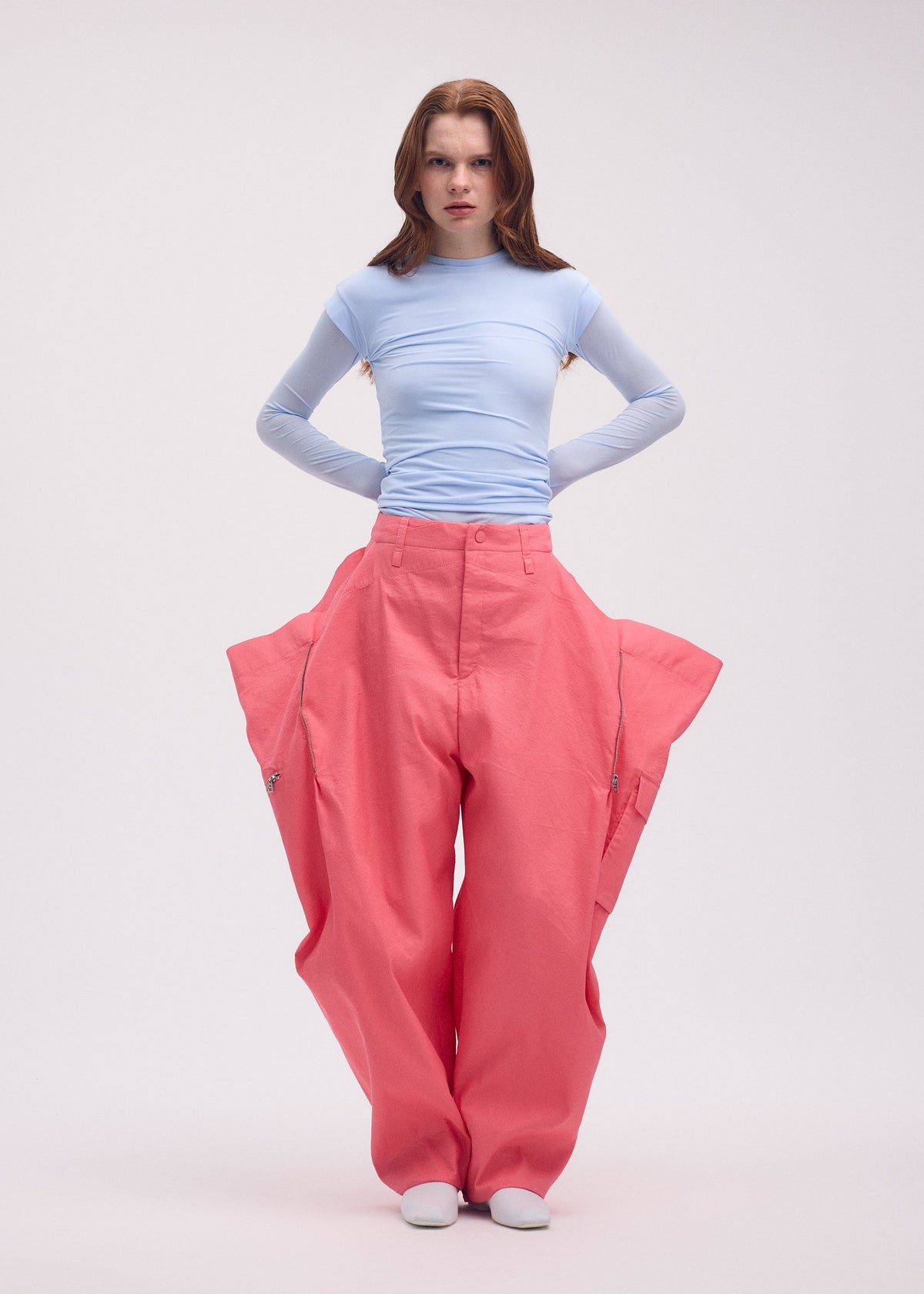 A model wears the Issey Miyake PEEKABOO trousers.